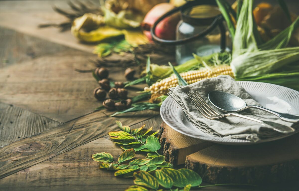 Fall table setting for Thanksgiving day celebration with cutlery, candle