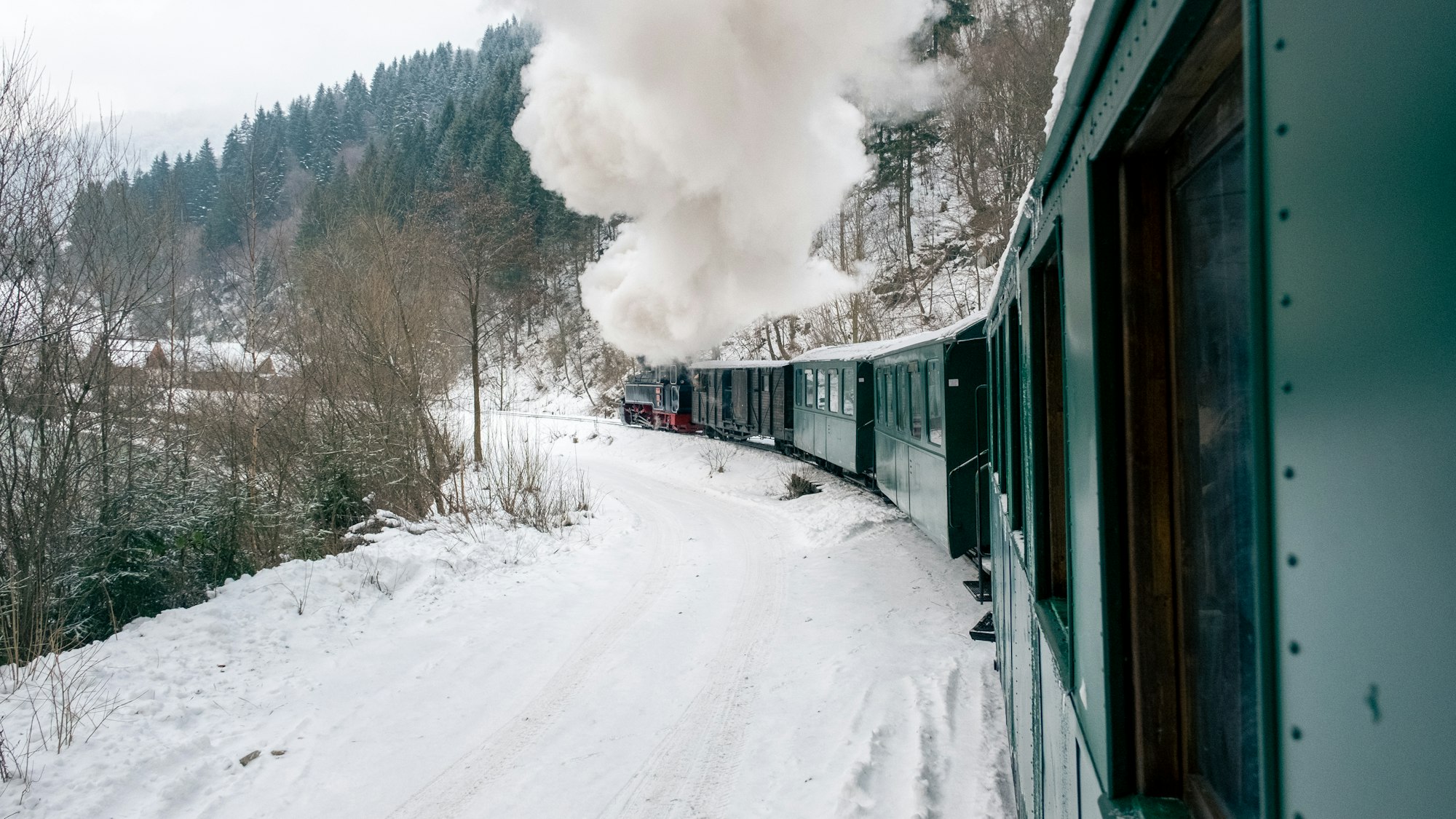 Moving steam train Mocanita from inside it in winter, Romania